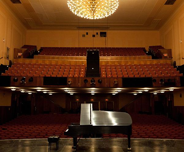 large concert hall with grand piano on stage