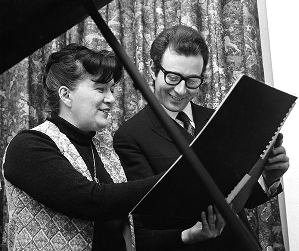 man and woman study an orchestral score